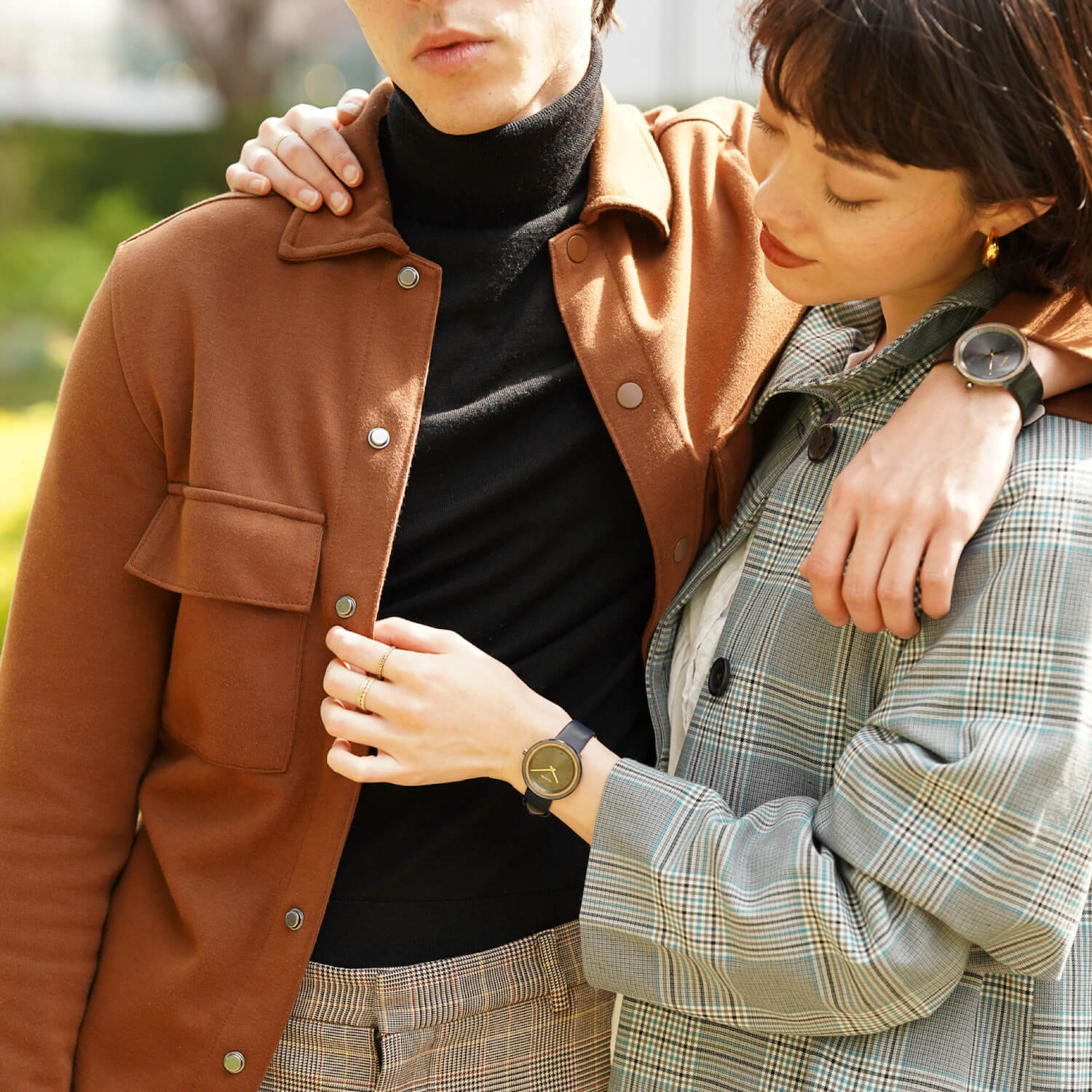 simple black watches on male and female wrist