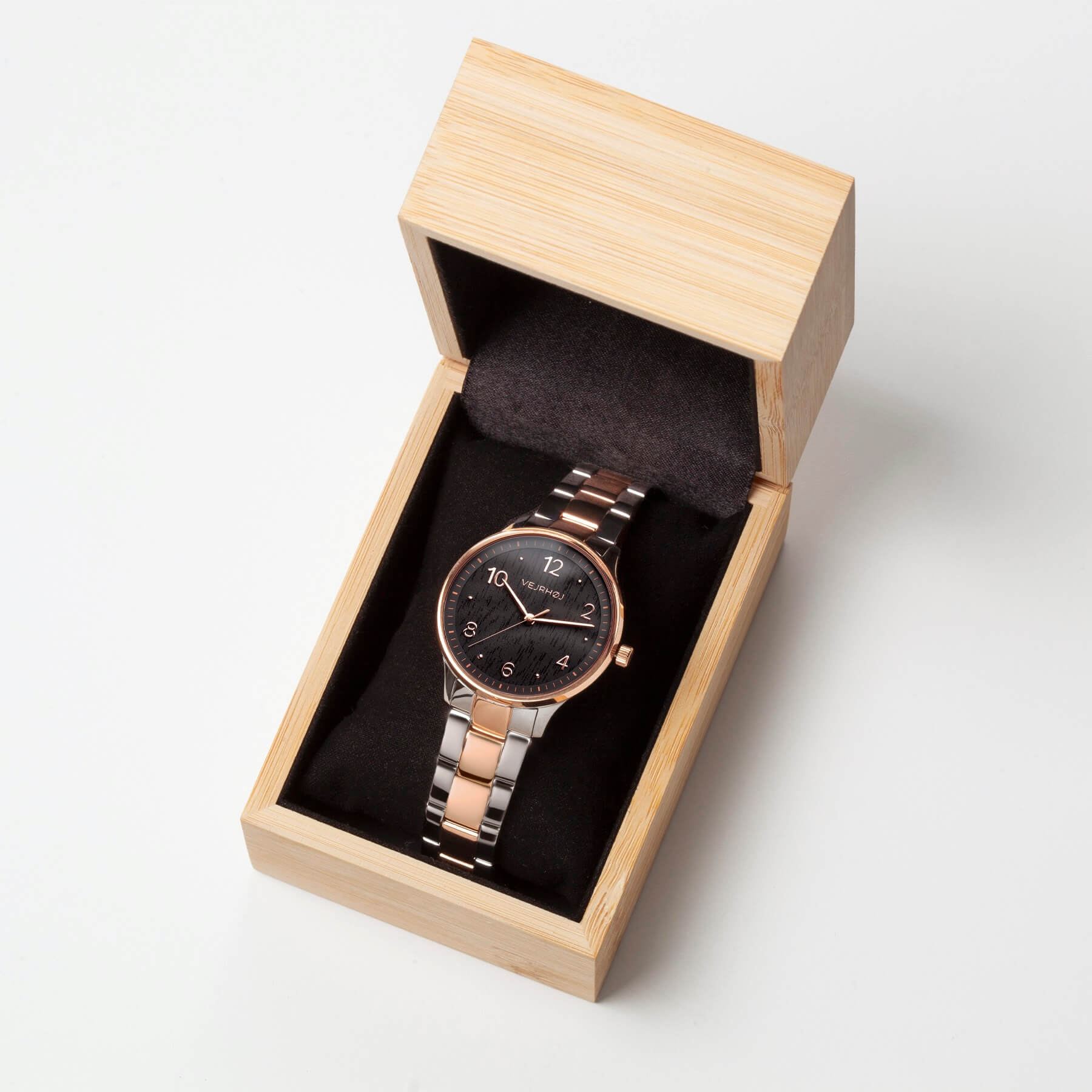 Vejrhøj's Petite Royal Black, a modern wood watch perfect for gift giving, presented in a natural bamboo box.
