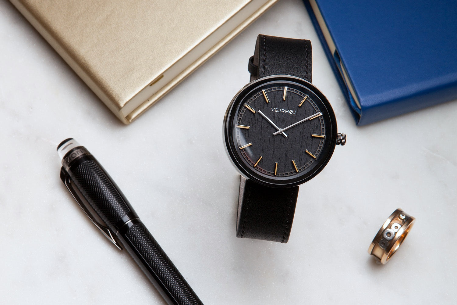 Black wood watch with gold hour markings from nordic watch company vejrhøj