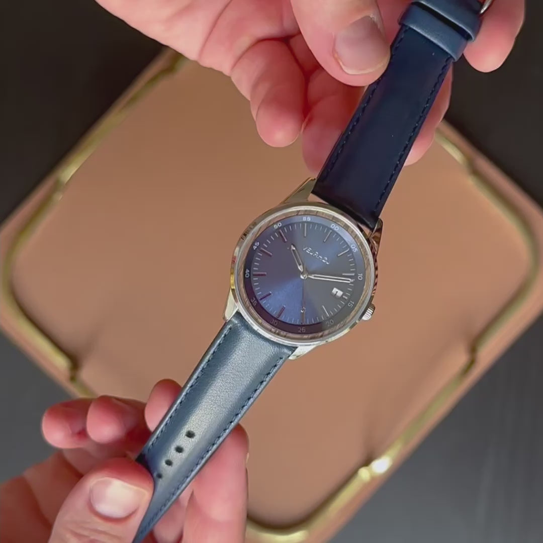 blue automatic VEJRHØJ watch with walnut wood encircling the dial  