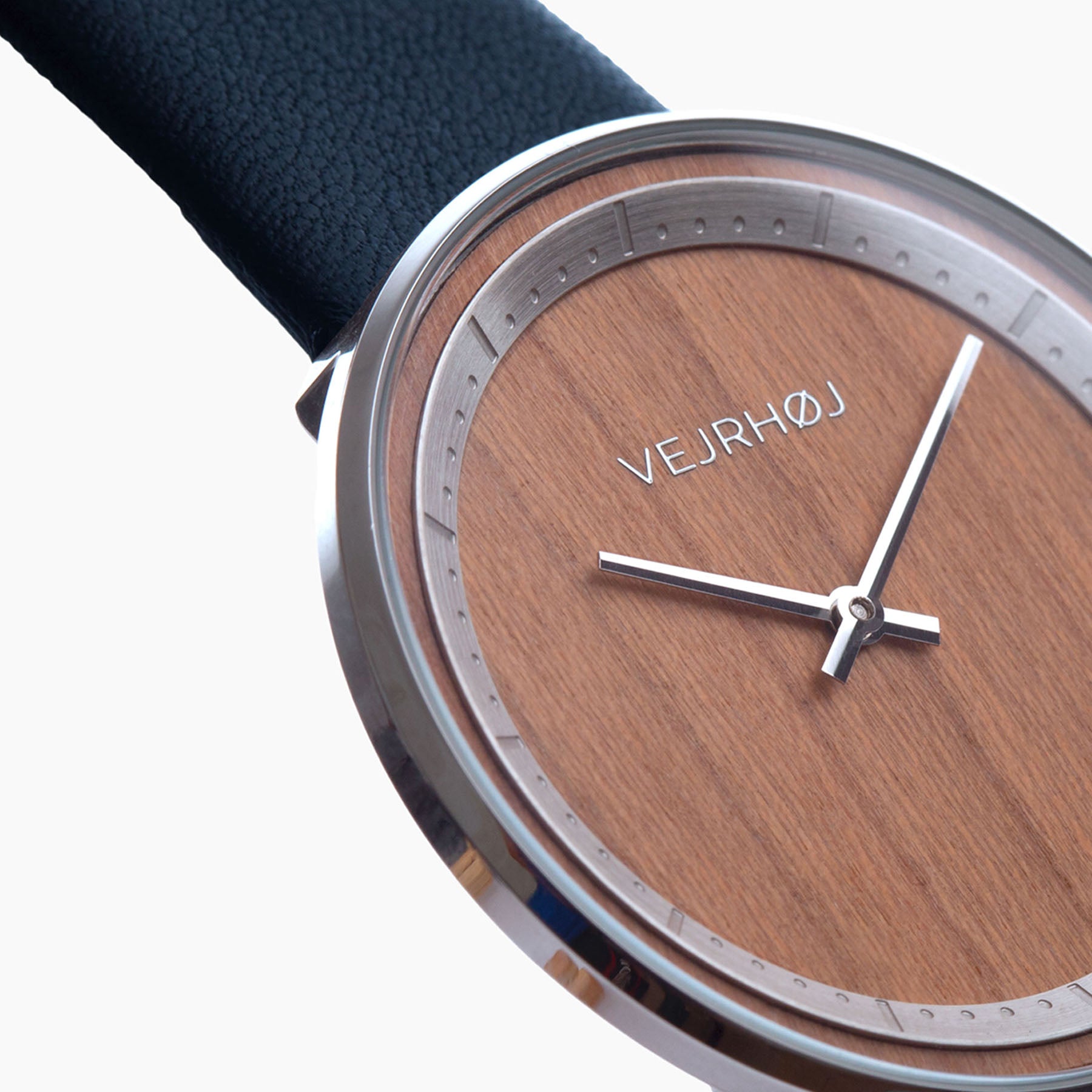 Close up of wooden watch with silver hands and silver casing